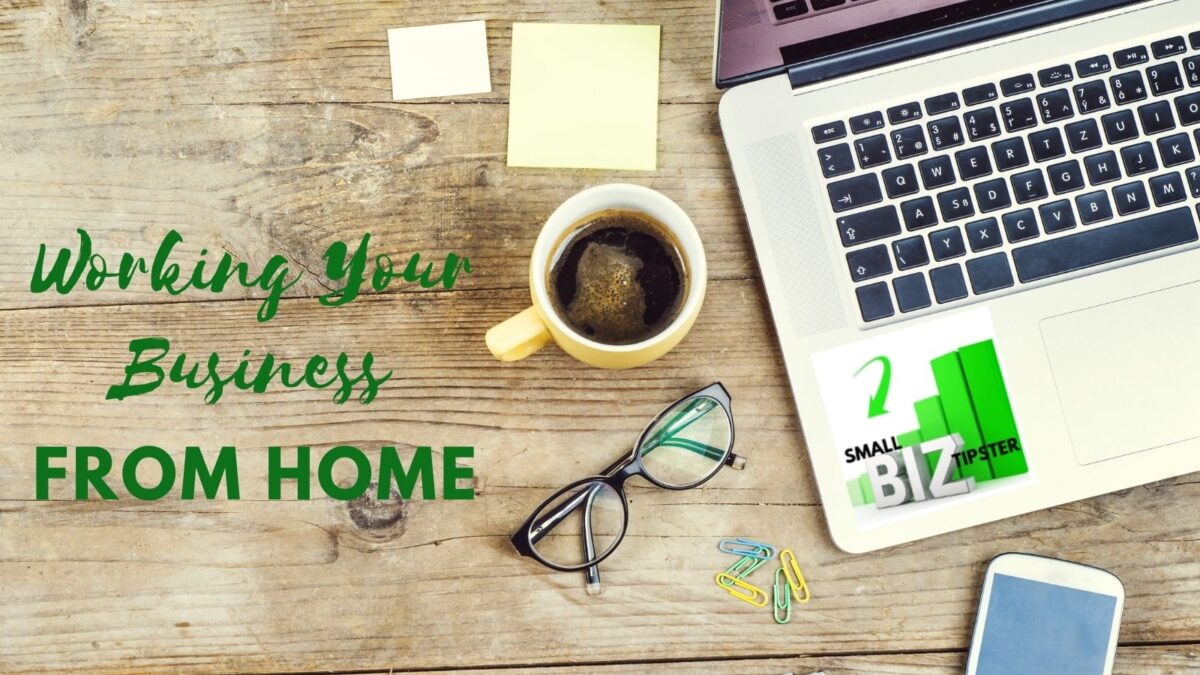 Modern home office setup with laptop, coffee mug, and glasses on wooden desk - working your business from home efficiently in 2026